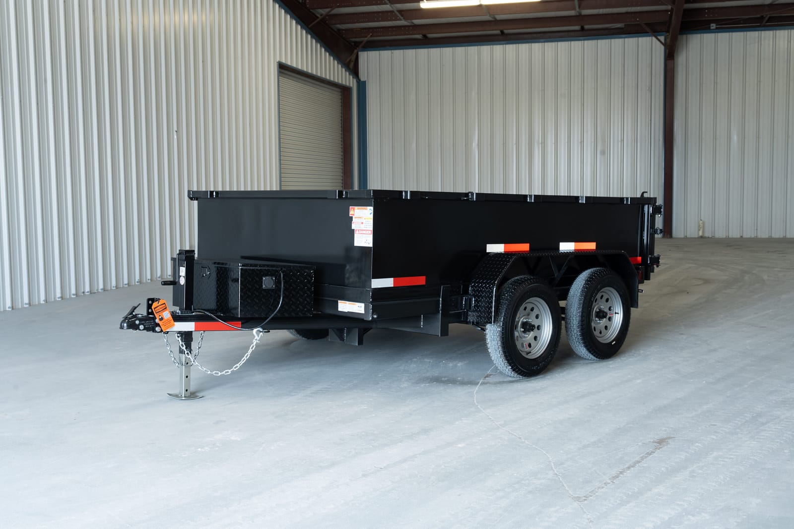 Black tandem-axle 6x10 hydraulic dump trailer for rent at Dump & Go Rentals in Texarkana, TX